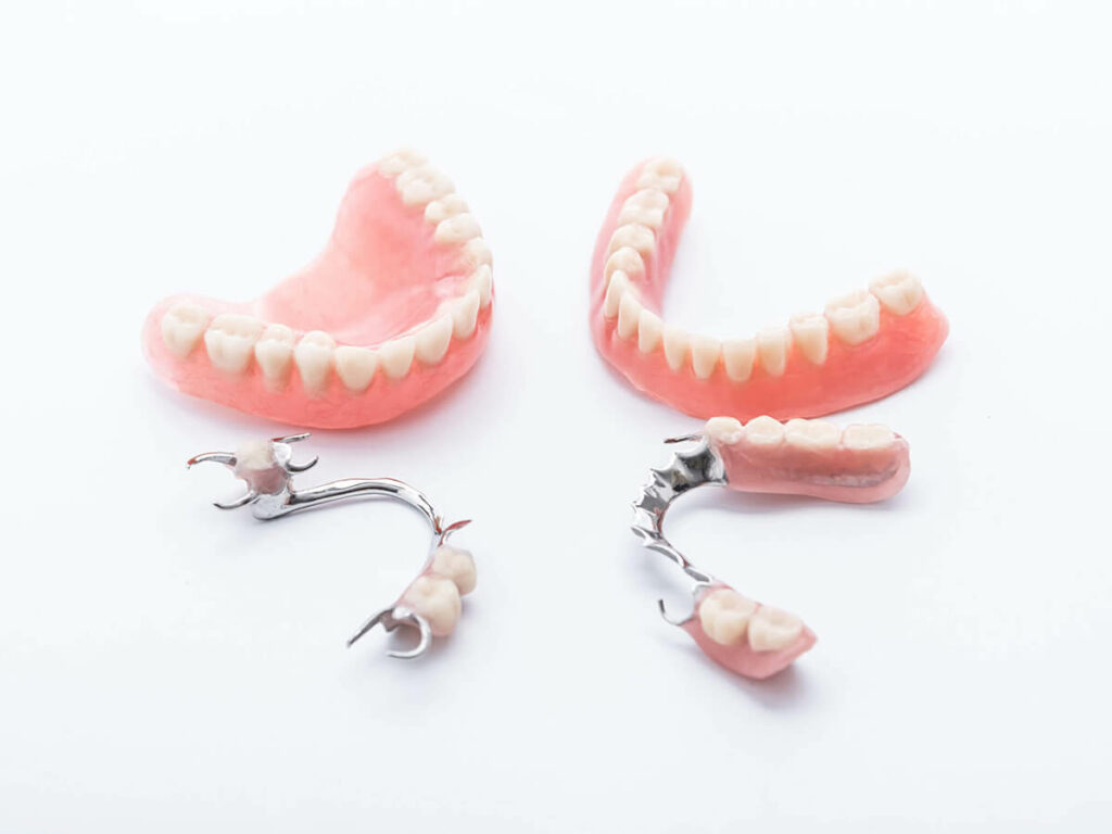 picture of dentures next to partial dentures